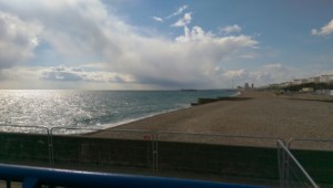 Brighton Beach with a calm sea and the peir in the distance