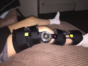 New black brace with soft padded supports and clear plastic dial.