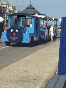 A long Blue beach train with a quite scary red lipped one tooth smile