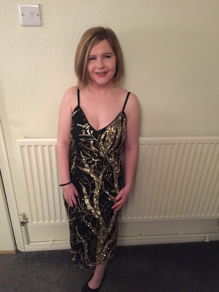 Sassy in a Black and gold sequin Dress with spaghetti straps