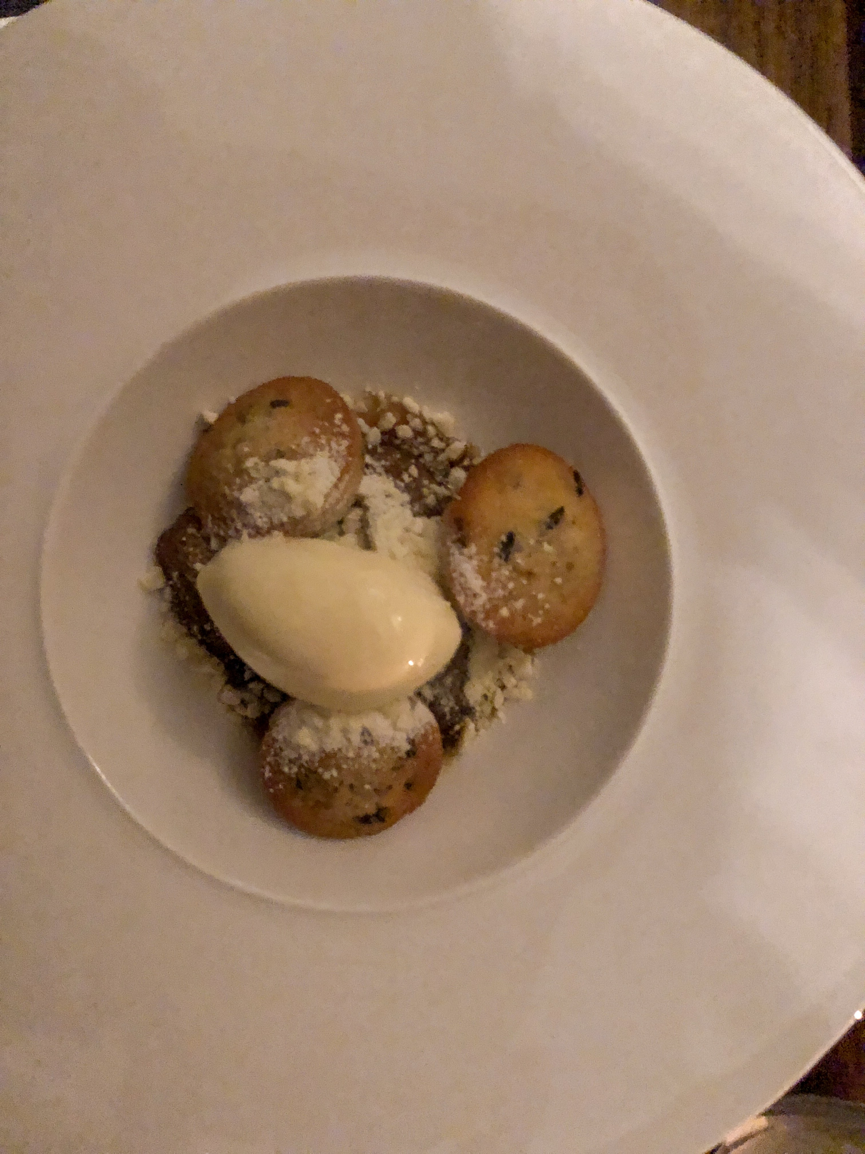 Vanilla Baked pear with a scoop of ice cream resting on top