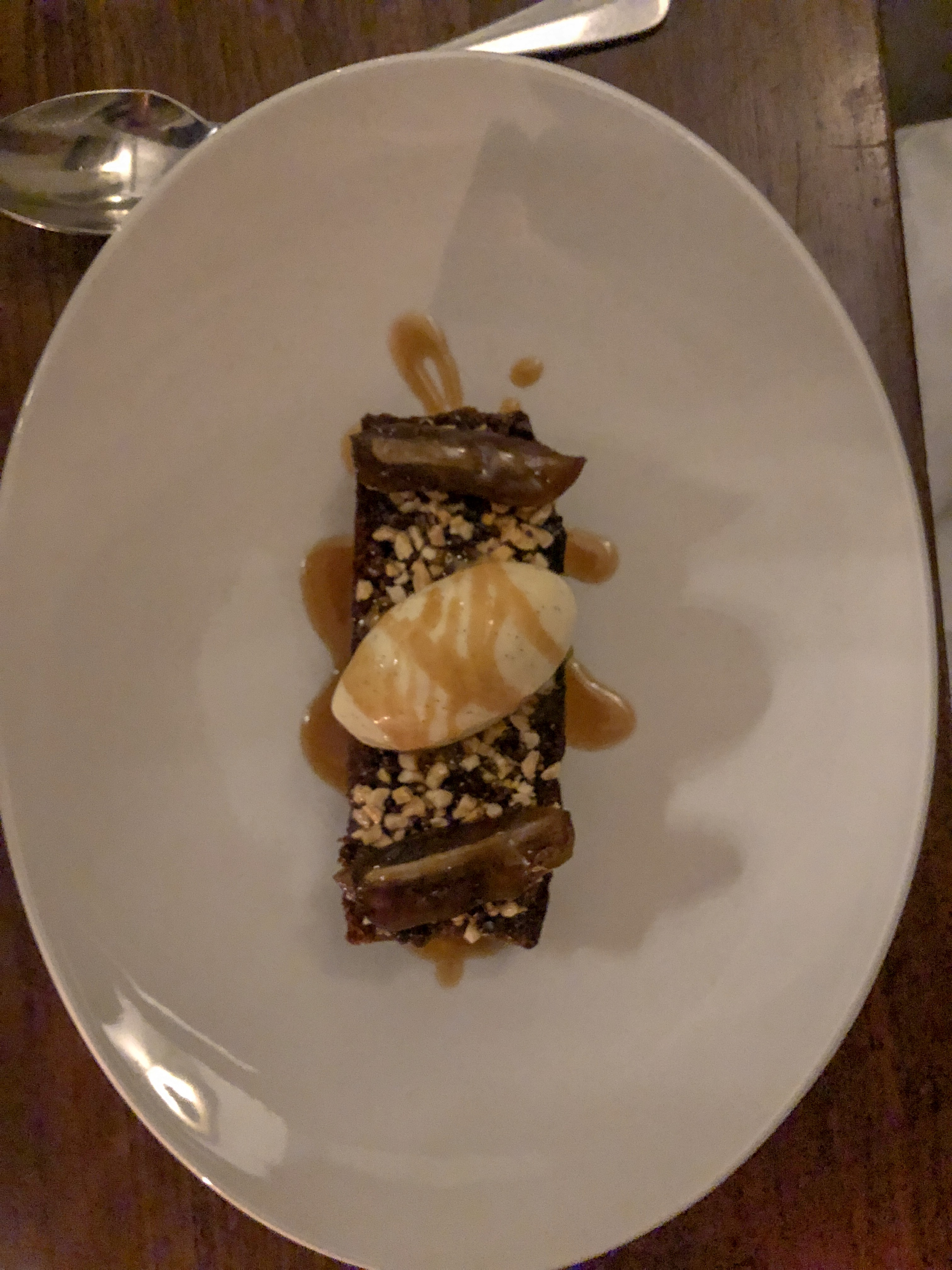 Sticky Toffee Pudding with a scoop of Ice cream resting in the center