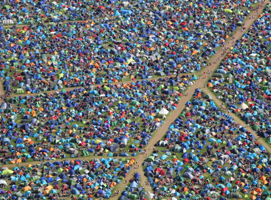An aerial shot of a hundreds of tents at a festival