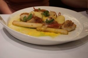 Scallops and chorizo pieces in a butter sauce
