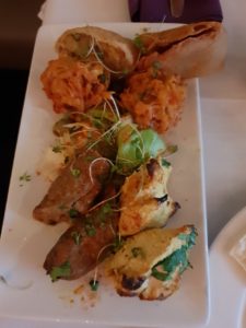 Started on a rectangle plate. From top to bottom are: Vegetable Samosa, Onion Garam Pakora, Murgh Malai Tikka,Tulsi Sheekh