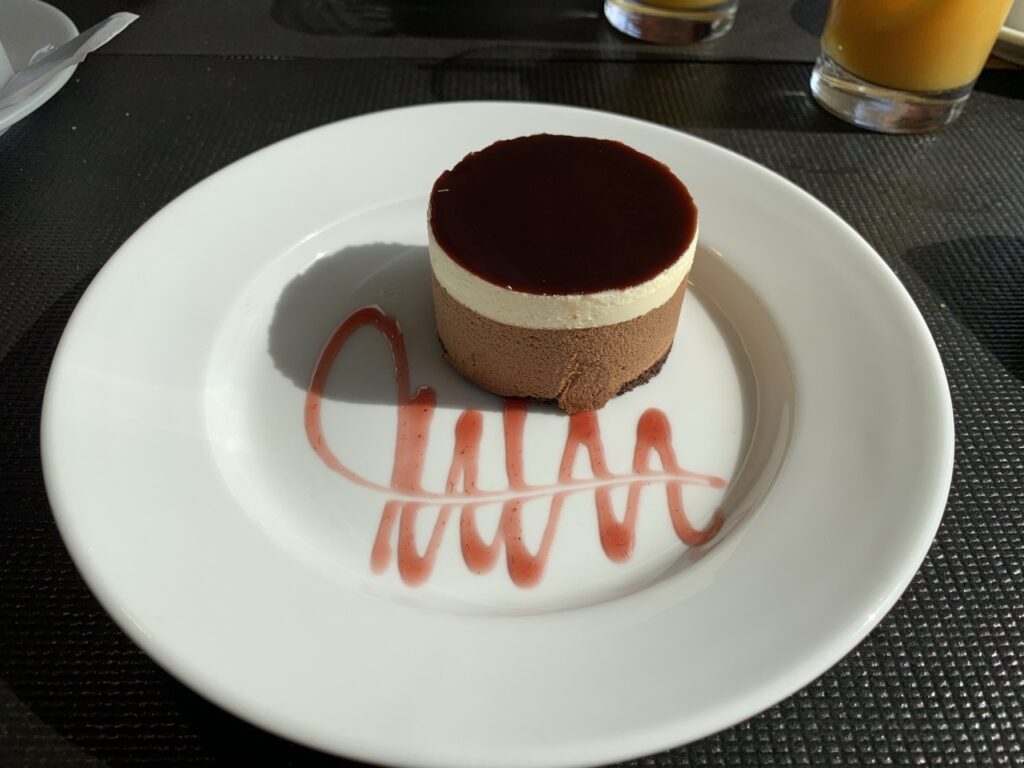 Triple chocolate dessert with a rasberry sauce swirl