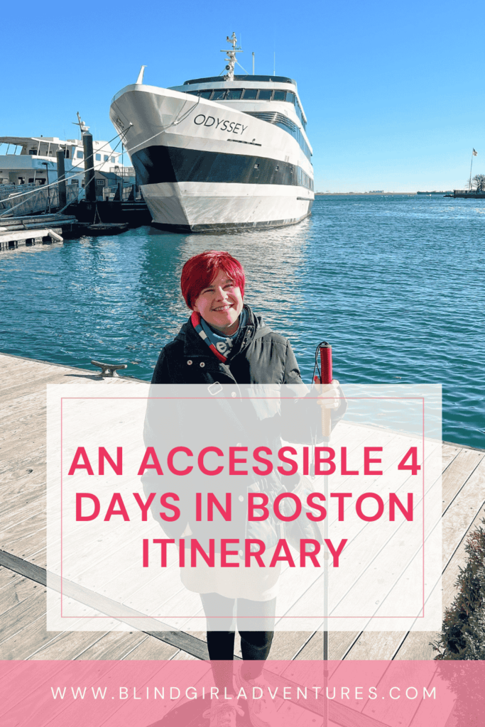 The pin for this article: Sassy smiling at the camera, on a pier. She is wearing a cream skirt, black leggings, white trainers, a black jacket, blue and red scarf, and a black bag. She is holding her white cane, which has a red handle. Behind her, there is a large yacht named Odyssey anchored by another pier. On top of the photo, in the bottom half, there is a transparent grey rectangular with "An accessible 4 days in Boston itinerary" written on it in dark pink letters. At the bottom of the photo there is a pink line with the name of the website on it.
